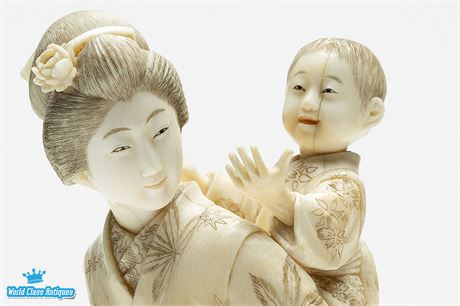 A Japanese Ivory Okimono of a Lady and Child, Circa 1900