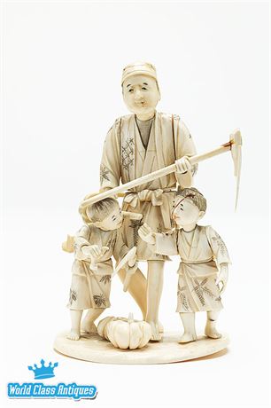 A Japanese Ivory Okimono of a Farmer and Two Children, Circa 1900