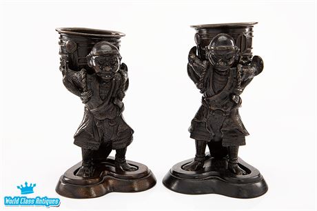 A Pair of Bronze Okimono Figures Carrying Temple Bells