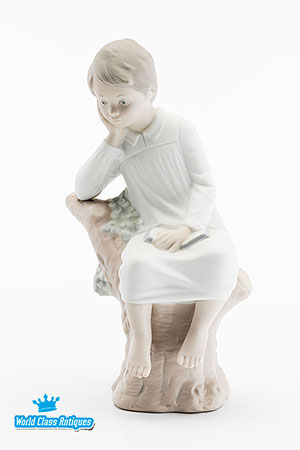 Lladro porcelain figurine with a matte finish - Thinking Boy Sitting on Tree Stump Reading Book 